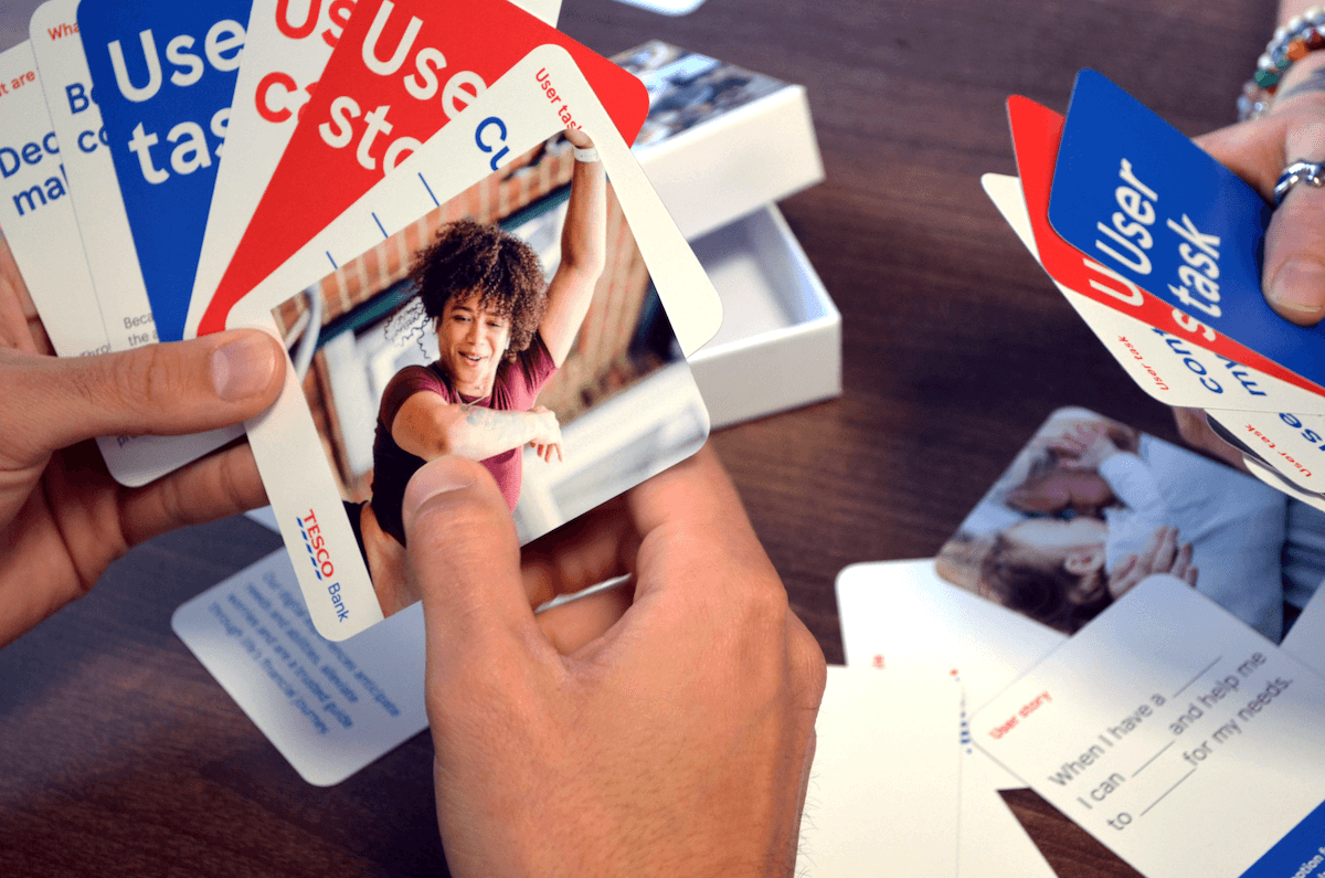 hands holding Tesco Bank user story cards
