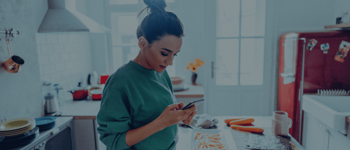 Woman in kitchen on phone